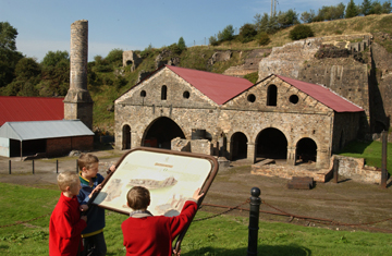 Children reading an information sign outside Blaenavon Ironworks