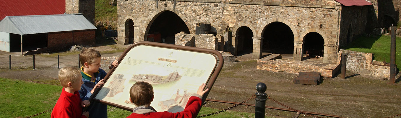 Children reading the information panel at Blaenavon Ironworks 