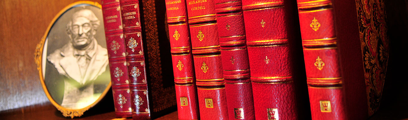 Photograph next to a row of red leather bound books