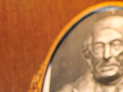 Photograph next to a row of red leather bound books
