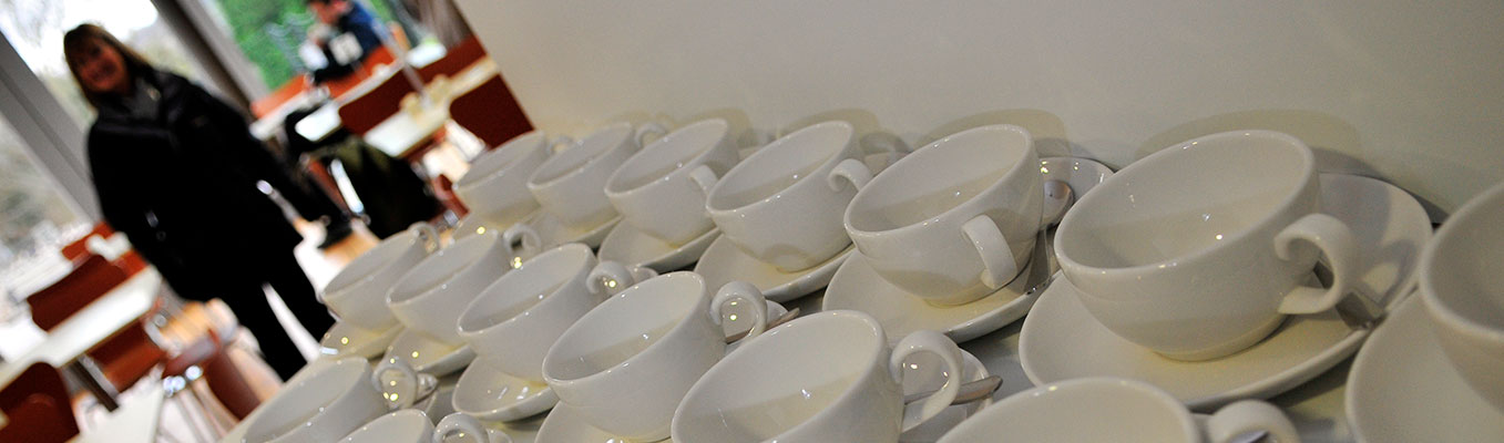 Cups and saucers laid out on table
