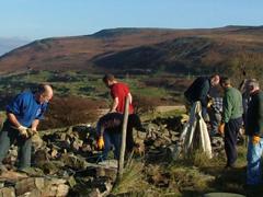 Volunteers helping with dry stone walling