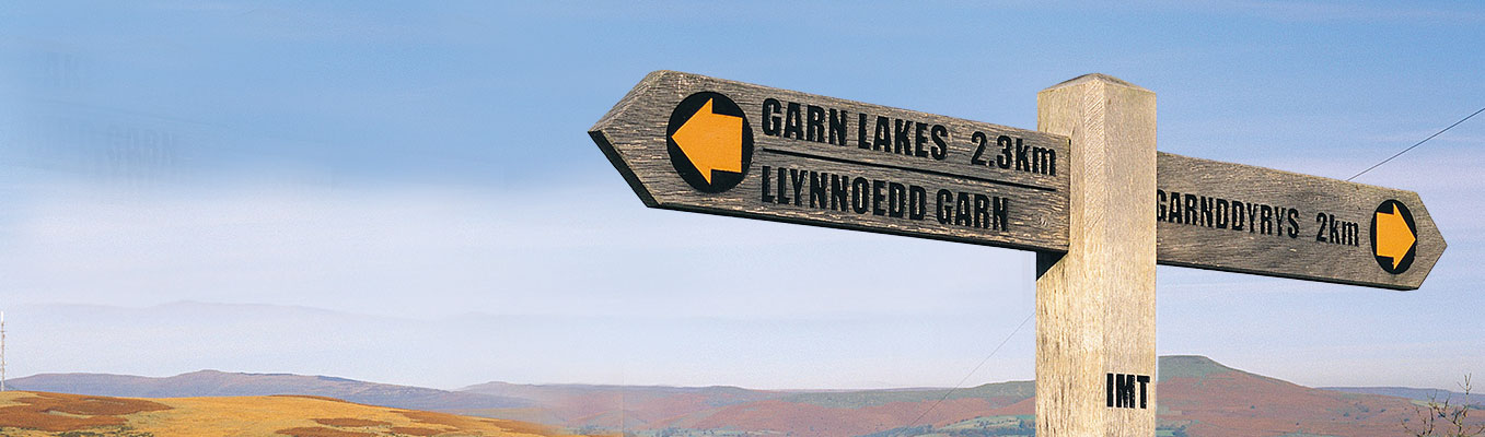 Waymarker sign with Brecon Beacons in background