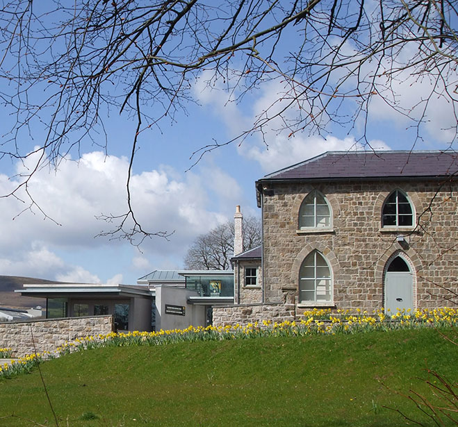 Exterior view of Blaenavon World Heritage Centre with daffodils growing in the grounds