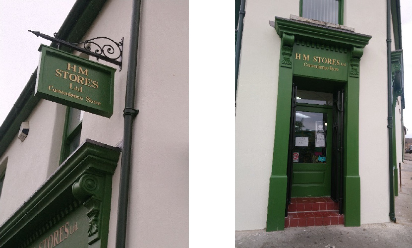 Exterior view of HM Stores, showing new signage and door replacement