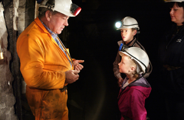 Children listening to a Miner talk at the Big Pit National Coal Museum