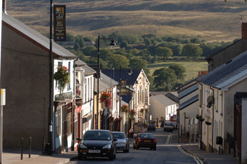 The main street in Blaenavon, many shops can be seen